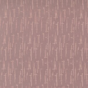 May include: A dusty rose fabric featuring a repeating pattern of vertical, dashed lines in a lighter shade of pink. The textile has a visible woven texture with a consistent, uniform arrangement of these abstract, elongated marks across the surface.