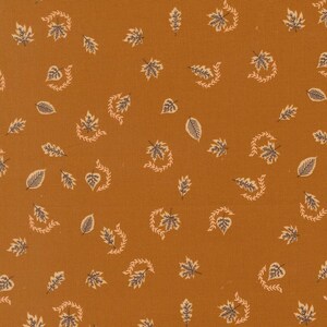 May include: A fabric with a solid mustard yellow background featuring a repeating pattern of small, dark grey leaves and delicate, curved vine-like sprigs scattered across the surface in a consistent, evenly spaced arrangement.