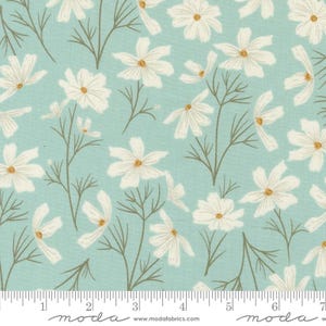 May include: White floral print fabric with a light blue background. The fabric features a repeating pattern of white flowers with yellow centres.