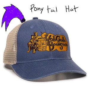 May include: A blue baseball cap with a mesh back and the words "Hob Gobs and Bootlicks" embroidered in gold. The cap has a curved brim and a purple ponytail graphic.