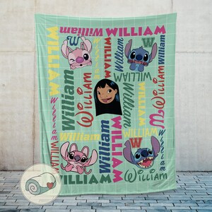 May include: A light green blanket featuring cartoon characters and the name "William" in various colors and fonts. The blanket has a grid pattern and includes images of Stitch and Lilo.