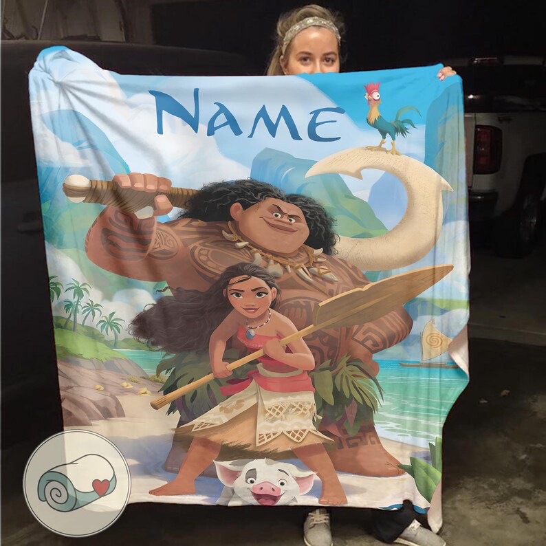 May include: A large, rectangular blanket featuring a colorful illustration of characters from a popular animated movie. The design includes a large figure holding a weapon, a woman holding a paddle, and a pig. The word "NAME" is printed at the top.