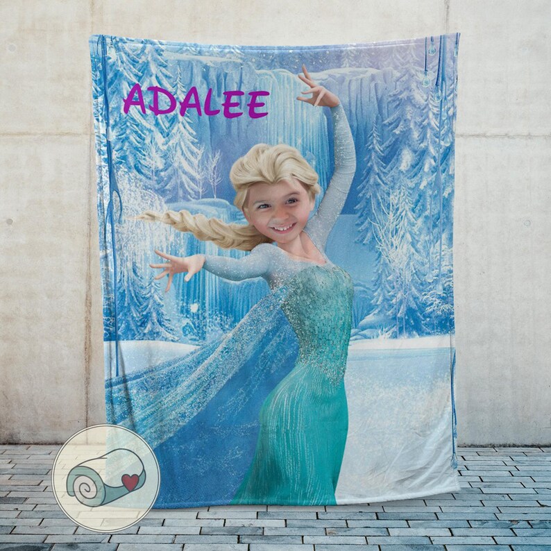May include: A personalized blanket featuring a digitally altered image of a young girl as a princess, with the name "ADALEE" in pink script. The blanket has a blue and white winter scene background.