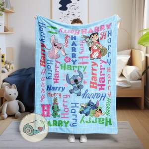 K&ouml;nnte beinhalten: Eine hellblaue Decke mit Zeichentrickfiguren und dem Namen "Harry" in verschiedenen Schriftarten und Farben. Die Decke hat ein Gittermuster und enth&auml;lt Illustrationen von Stitch und anderen Charakteren aus dem Animationsfilm.