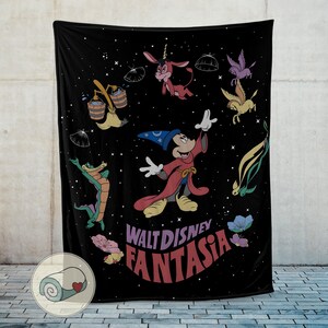 May include: Black throw blanket with a colourful illustration of Mickey Mouse as a sorcerer, and other Fantasia characters. The blanket has the words "Walt Disney Fantasia" in a retro font. The design is set against a starry background.
