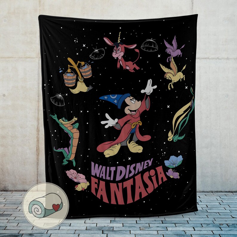 May include: Black throw blanket with a colourful illustration of Mickey Mouse as a sorcerer, and other Fantasia characters. The blanket has the words "Walt Disney Fantasia" in a retro font. The design is set against a starry background.