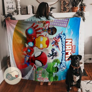 May include: A large, rectangular Marvel "Awesome Friends" blanket featuring colorful illustrations of superheroes, including Iron Man, Spider-Man, and Hulk. The blanket has a blue background with the Marvel logo and the words "Awesome Friends".