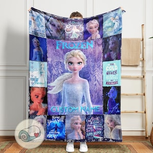May include: A large, rectangular Frozen-themed blanket featuring Elsa. The design includes various images of Elsa, the text "Frozen", and other phrases like "Can't Be Trusted" and "The Cold Never Bothered Me Anyway". The blanket is predominantly blue and purple.