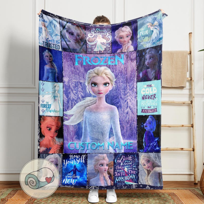May include: A large, rectangular Frozen-themed blanket featuring Elsa. The design includes various images of Elsa, the text "Frozen", and other phrases like "Can't Be Trusted" and "The Cold Never Bothered Me Anyway". The blanket is predominantly blue and purple.
