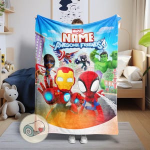 May include: A blue Marvel "Name Awesome Friends" blanket featuring cartoon illustrations of superheroes including Iron Man, Spider-Man, and Hulk. The blanket has a sky background with clouds and the Marvel logo.