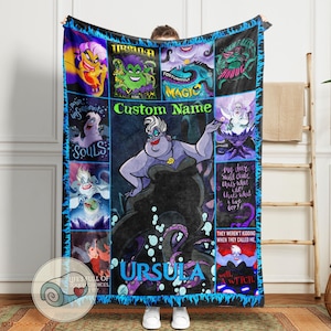 May include: A plush, rectangular blanket featuring a collage of images of Ursula from The Little Mermaid. The blanket has a black border with blue accents and includes the text "Custom Name" and "URSULA".