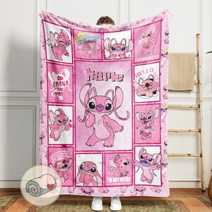 May include: A pink fleece blanket featuring a collage of images of the character Angel from Lilo & Stitch. The blanket has a grid pattern with various poses of Angel, along with the text "Name", "Ohana means family", and "I'm not weird I'm limited edition".