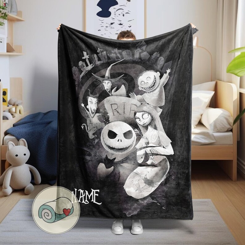 May include: Black and white fleece blanket featuring characters from The Nightmare Before Christmas. The design includes Jack Skellington, Sally, and other characters in a graveyard scene. The blanket has a rolled-up image with a heart.