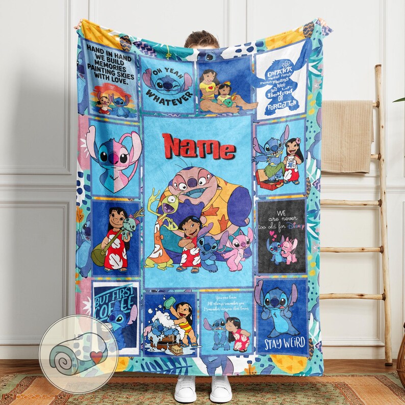 May include: A colorful throw blanket featuring cartoon characters and text. The blanket has a blue background with various squares displaying images of Stitch and Lilo. Text includes "Name", "Ohana", and "Stay Weird".
