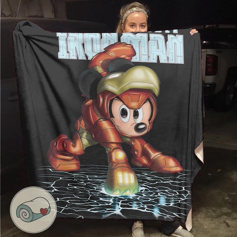 May include: Black blanket featuring a cartoon Mickey Mouse in an Iron Man suit. The blanket has the words "IRON MAN" in light blue block letters at the top. The background has a black and white lightning design.