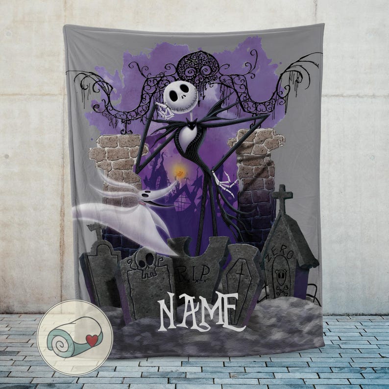 May include: A gray blanket featuring a graphic of Jack Skellington from The Nightmare Before Christmas, standing in a graveyard with Zero the ghost dog. The background includes a purple sky and a spooky town.