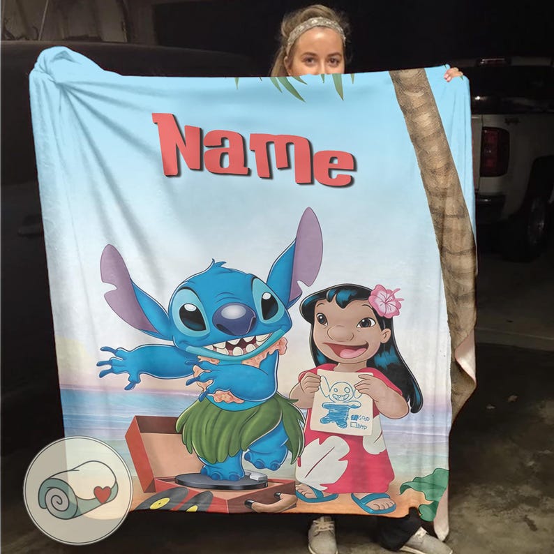May include: A light blue blanket featuring the characters Stitch and Lilo from the Disney movie Lilo & Stitch. The blanket has the word "Name" in red letters at the top. Stitch is in a hula skirt, and Lilo is holding a drawing of Stitch.