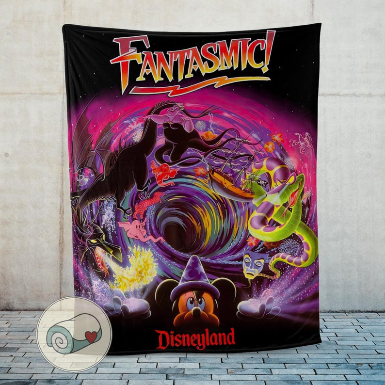 May include: Black blanket featuring the word "FANTASMIC!" in orange and yellow. The blanket has a colorful illustration of Disney characters, including Mickey Mouse in a wizard hat, dragons, and a snake. The word "Disneyland" is printed in red.