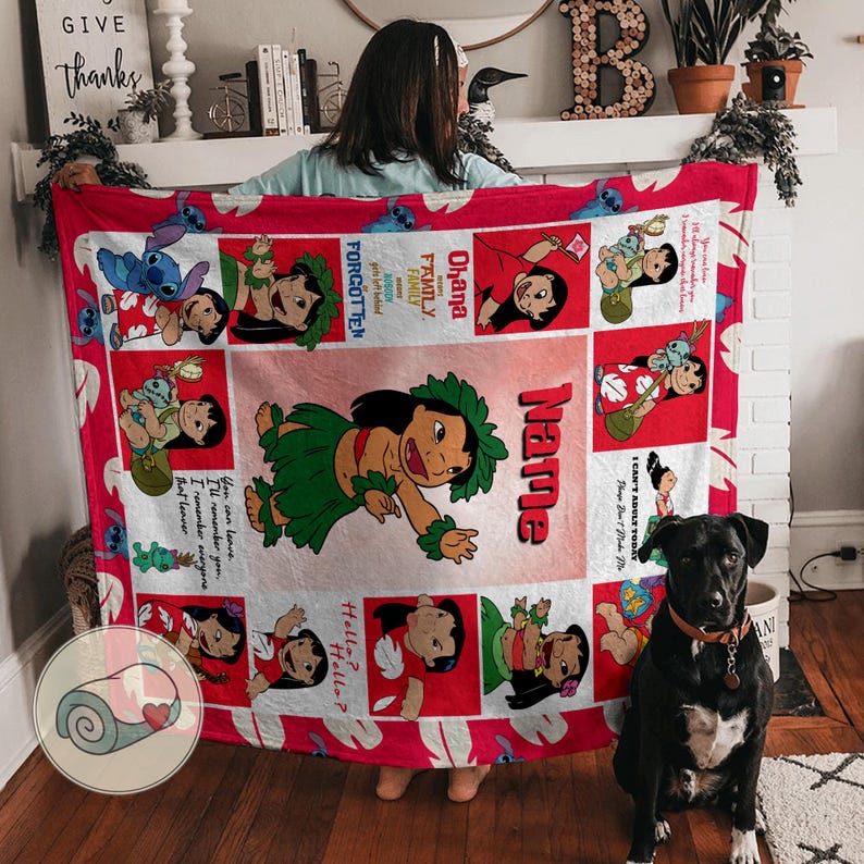 May include: A red and white blanket featuring cartoon images of Lilo and Stitch. The blanket has a red border and includes the text "Ohana Family" and "I Can't Adult Today". The blanket is held up by a person.