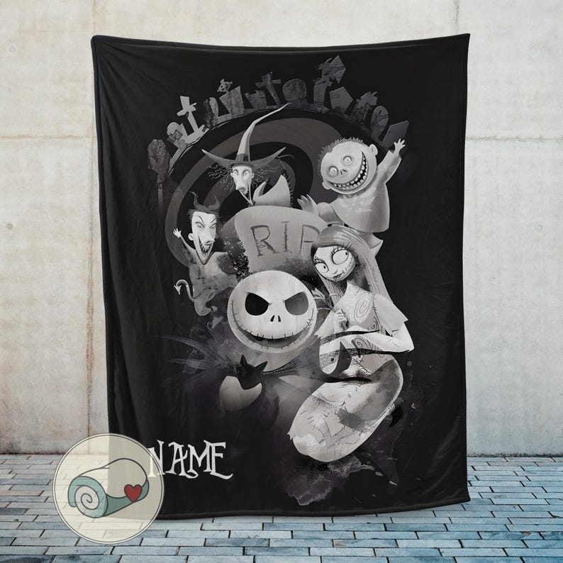 May include: Black throw blanket featuring a grayscale illustration of characters from The Nightmare Before Christmas. The design includes Jack Skellington, Sally, and other characters, with a graveyard scene in the background. The word "NAME" is written in white.