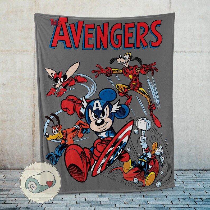 May include: A gray blanket featuring a comic-style illustration of Disney characters as The Avengers. Mickey Mouse is Captain America, with Goofy as Iron Man and Donald Duck as Thor. The text "The Avengers" is in red and blue.