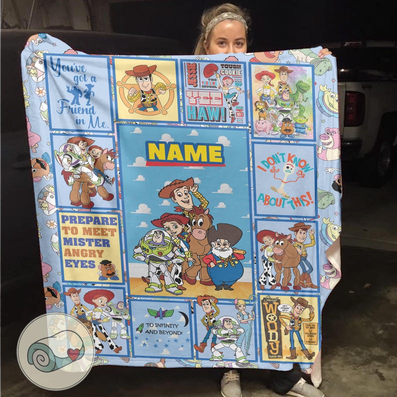 May include: A light blue blanket featuring characters from the Toy Story film series. The blanket displays images of Woody, Buzz Lightyear, and other characters, with phrases such as "You've got a Friend in Me" and "To Infinity and Beyond!"