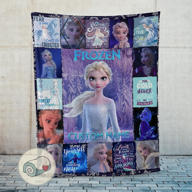 May include: A plush, rectangular blanket featuring the character Elsa from the movie Frozen. The design includes multiple images of Elsa, the word "FROZEN", and the option for a custom name. The color scheme is predominantly blue and purple.