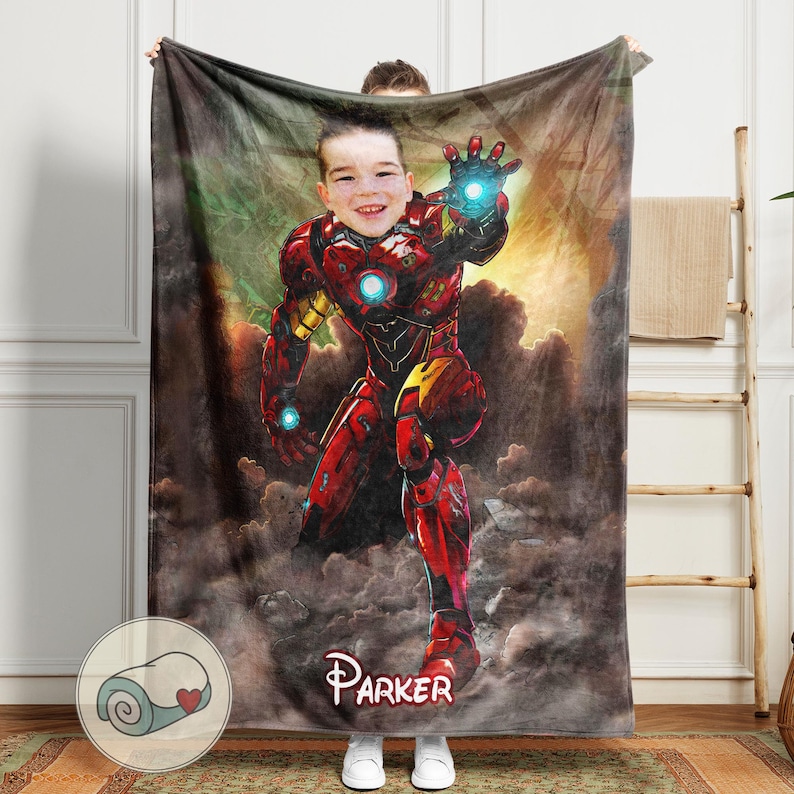 May include: A personalized plush blanket featuring a child's face superimposed on an Iron Man illustration. The blanket is predominantly red with yellow accents, and the child's name, "Parker," is displayed in a Disney-style font.