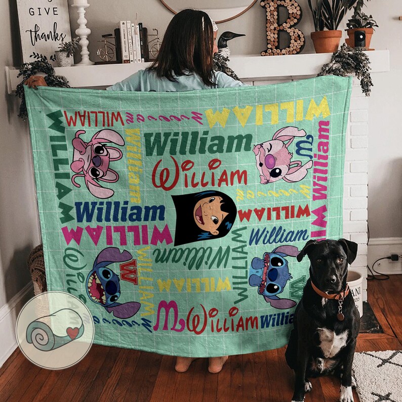May include: A light green blanket featuring cartoon characters and the name "William" in various fonts and colors. The blanket has a grid pattern and includes images of Stitch and Lilo.