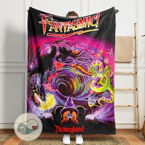 May include: Black blanket featuring the word "Fantasmic!" in red and yellow, with a colorful graphic of Disney characters. The blanket includes the Disneyland logo at the bottom.