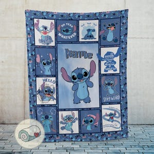May include: A blue throw blanket featuring the character Stitch from Lilo & Stitch. The blanket has a repeating pattern of Stitch in various poses, with phrases like "Oh Yeah Whatever" and "Stay Weird". The word "Name" is also visible.