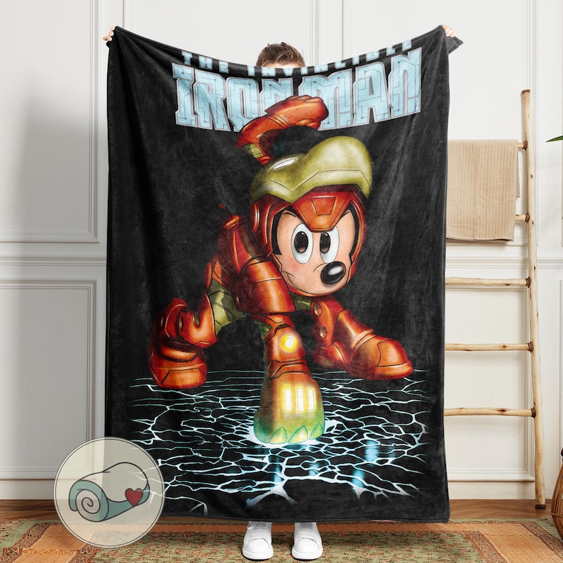 May include: Black blanket featuring a cartoon character in an Iron Man suit. The character is red, gold, and green, with the words "IRON MAN" in light blue across the top. The background is black with a lightning bolt design.