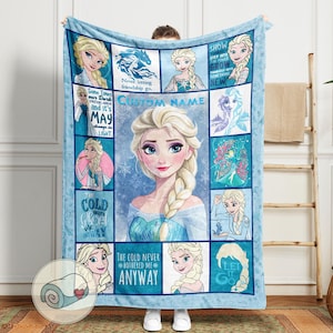May include: A light blue fleece blanket featuring Elsa from Frozen. The blanket has a central portrait of Elsa, surrounded by smaller images and text including "CUSTOM NAME", "The Cold Never Bothered Me Anyway", and "Let It Go".
