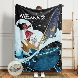 May include: A black blanket featuring a vibrant illustration from "Moana 2." The design includes Moana sailing on a boat, with a pig and rooster, set against a starry night sky. The blanket has the movie title at the top.