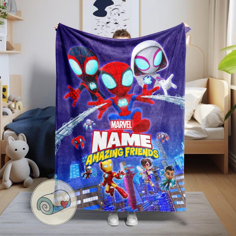 May include: A plush, purple Marvel blanket featuring Spider-Man and other characters. The blanket has the words "Marvel" and "Amazing Friends" in a colorful design, with a cityscape background.