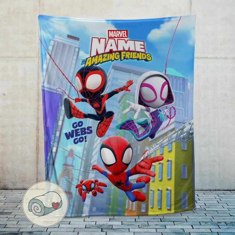 May include: A Marvel "Amazing Friends" blanket featuring cartoon Spider-Man characters in action poses against a city backdrop. The blanket has the text "Go Webs Go!" and a Marvel logo.