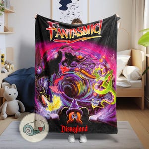 May include: Black blanket featuring the word "FANTASMIC!" in red and yellow, with a vibrant, swirling design of dragons, Mickey Mouse in a wizard hat, and other characters. The word "Disneyland" is printed in red at the bottom.