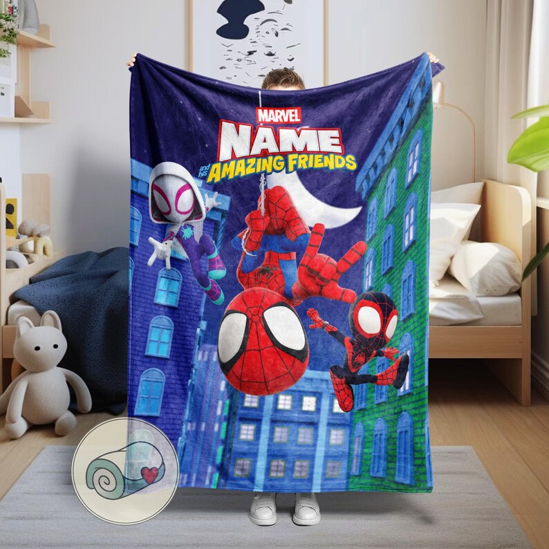 May include: A navy blue Marvel "Amazing Friends" blanket featuring Spider-Man, Spider-Gwen, and Miles Morales characters. The blanket has a cityscape background with a moon and the Marvel logo.