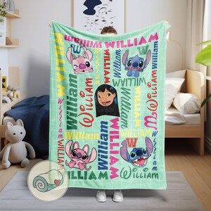 May include: A light green blanket featuring cartoon characters and the name "William" in various colors and fonts. The blanket has a grid pattern and includes images of Stitch, Angel, and Lilo.