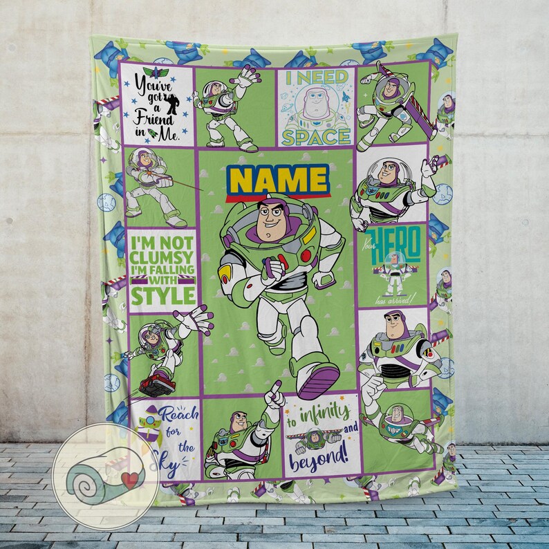 May include: A green blanket featuring Buzz Lightyear from Toy Story. The blanket has a grid pattern with various images of Buzz, along with phrases like "You've got a Friend in Me" and "Reach for the Sky". The word "NAME" is also displayed.
