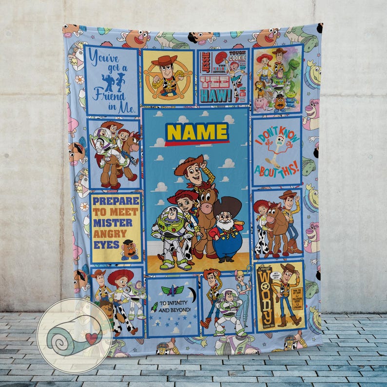 May include: A light blue blanket with a repeating pattern of animated film characters and quotes. The blanket features images of Woody, Buzz Lightyear, and other characters. Text includes "You've got a Friend in Me" and "To Infinity and Beyond."