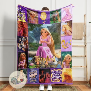 May include: A purple fleece blanket featuring images of Rapunzel from the movie Tangled. The blanket has the words "Go Live Your Dream", "You Are My New Dream", and "Tangled Custom Name" printed on it. The blanket is a cozy and decorative item.