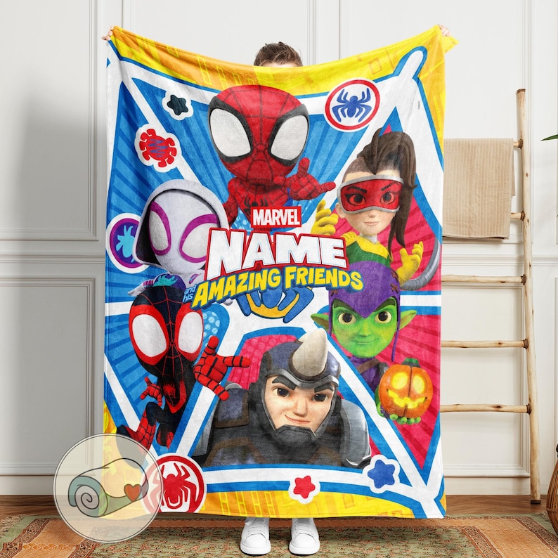 May include: A Marvel "Amazing Friends" blanket featuring Spider-Man and other characters. The blanket has a blue and yellow background with character illustrations and the text "NAME AMAZING FRIENDS".