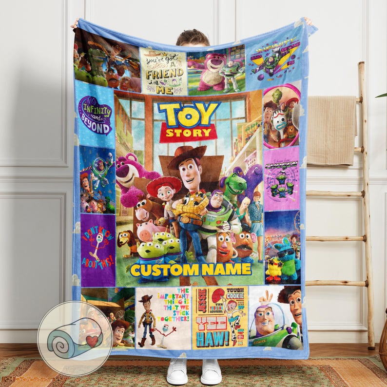 May include: A blue fleece blanket featuring characters from the animated film "Toy Story." The blanket has a central image of Woody and Buzz Lightyear, surrounded by other characters and phrases like "Infinity and Beyond" and "You've Got a Friend in Me."