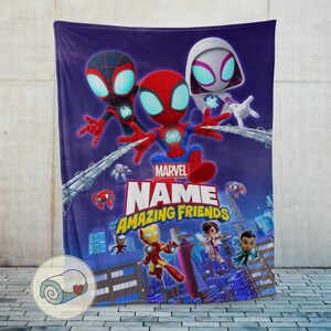 May include: A purple Marvel Amazing Friends blanket featuring Spider-Man, Miles Morales, and Spider-Gwen. The blanket has a cityscape background and the Marvel logo. The blanket is made of soft material.