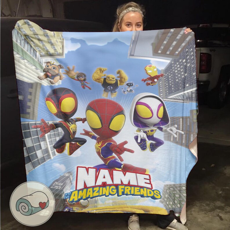 May include: A colorful blanket featuring cartoon characters, including Spider-Man and other heroes, against a cityscape backdrop. The blanket has the text "NAME" and "THE AMAZING FRIENDS" in a bold font. The blanket is a vibrant mix of blues, reds, and yellows.