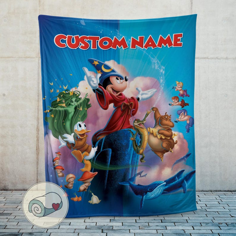 May include: A blue blanket featuring a colorful illustration of Mickey Mouse as a sorcerer, with other Disney characters. The blanket has the text "CUSTOM NAME" in red across the top. The blanket is made of a soft material.