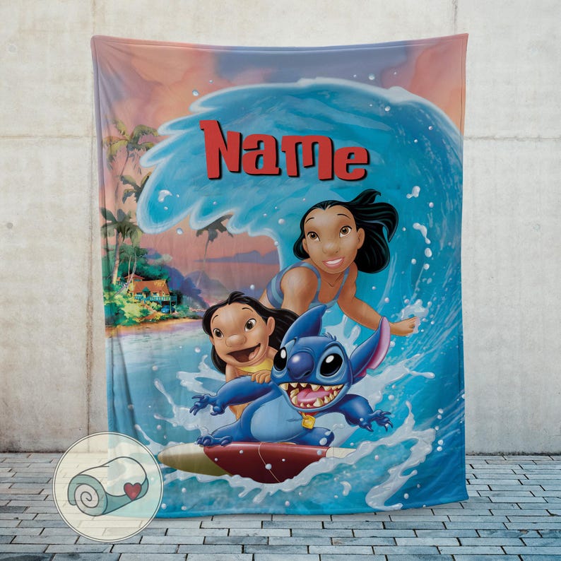May include: A blue and white blanket featuring the characters Lilo and Stitch surfing a wave. The blanket has the word "Name" in red across the top. The background shows a tropical beach scene.