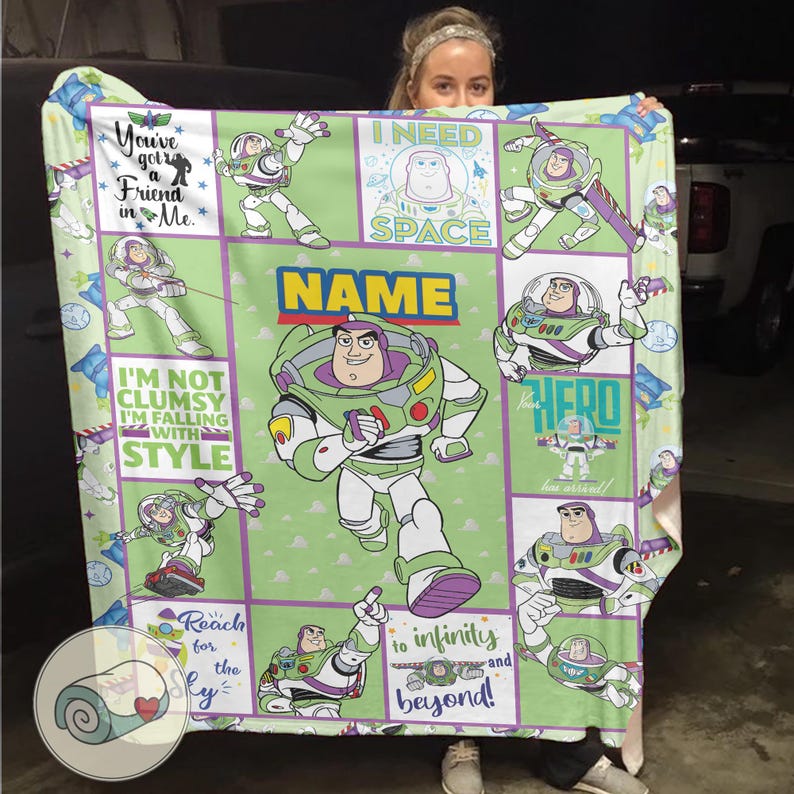 May include: A green and white blanket featuring Buzz Lightyear from Toy Story. The blanket has various images of Buzz Lightyear with phrases like "I need space" and "to infinity and beyond!" The blanket has a personalized name section.