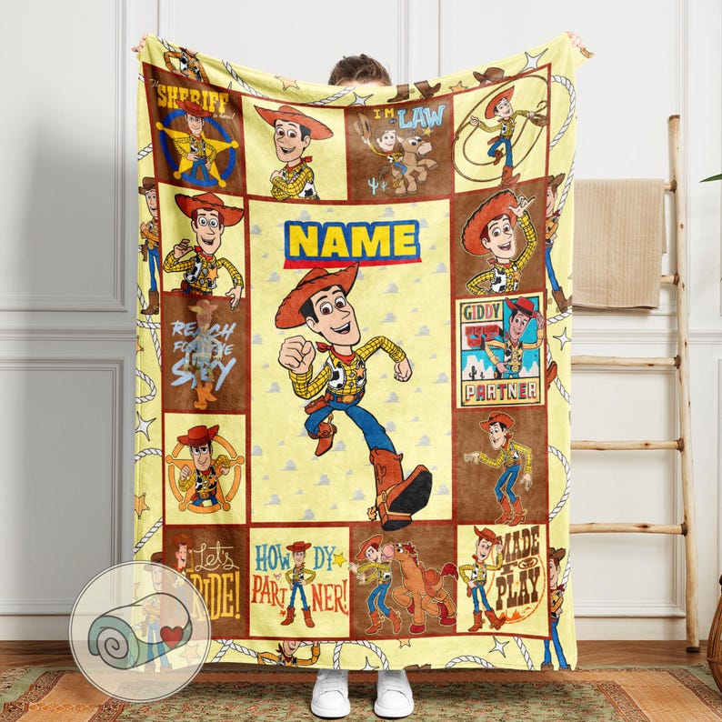 May include: A yellow blanket featuring a cartoon cowboy character in various poses. The blanket has a repeating pattern of the character and text, including "SHERIFF", "NAME", and "Giddy Partner". The blanket is approximately 60 inches wide and 80 inches long.